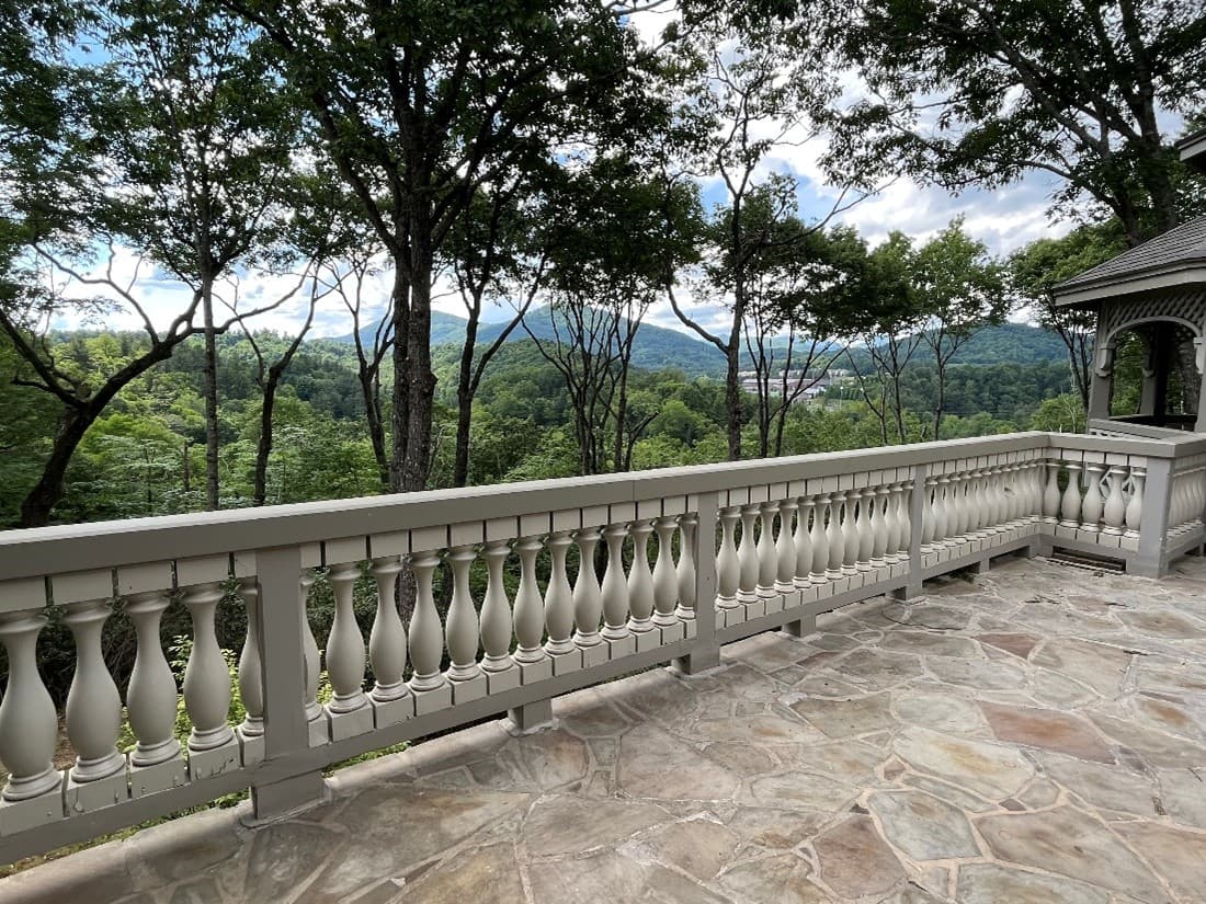 Balcony with clear mountain view through trimmed trees
