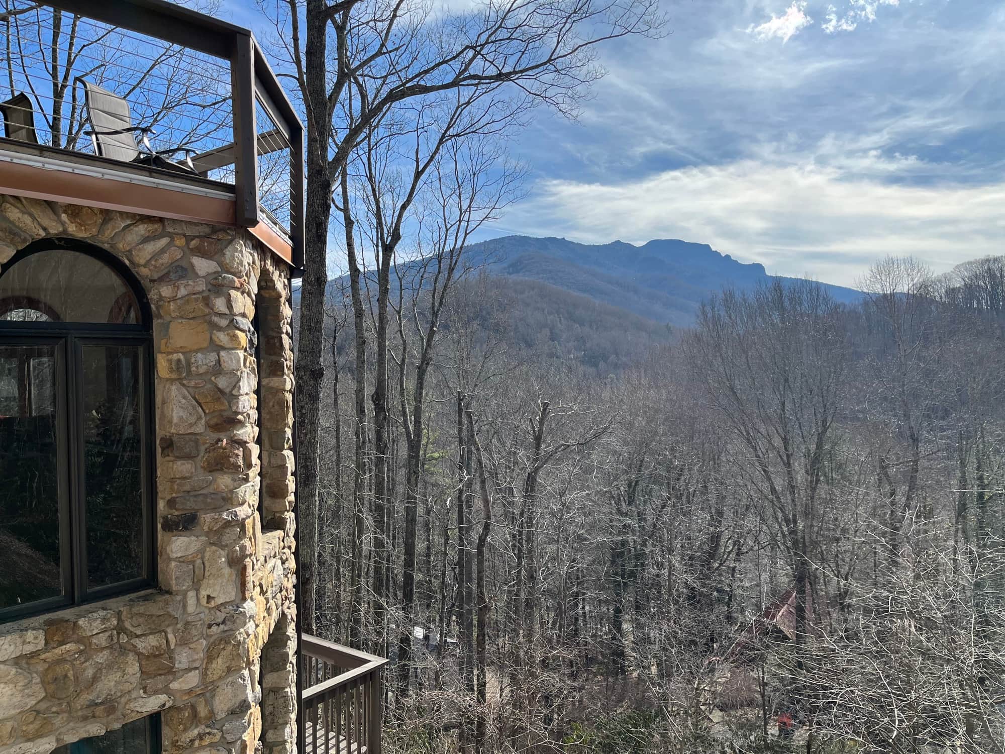 Stone house with mountain view after tree clearing and view enhancement