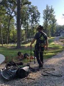 One of our arborists examining their tree service equipment